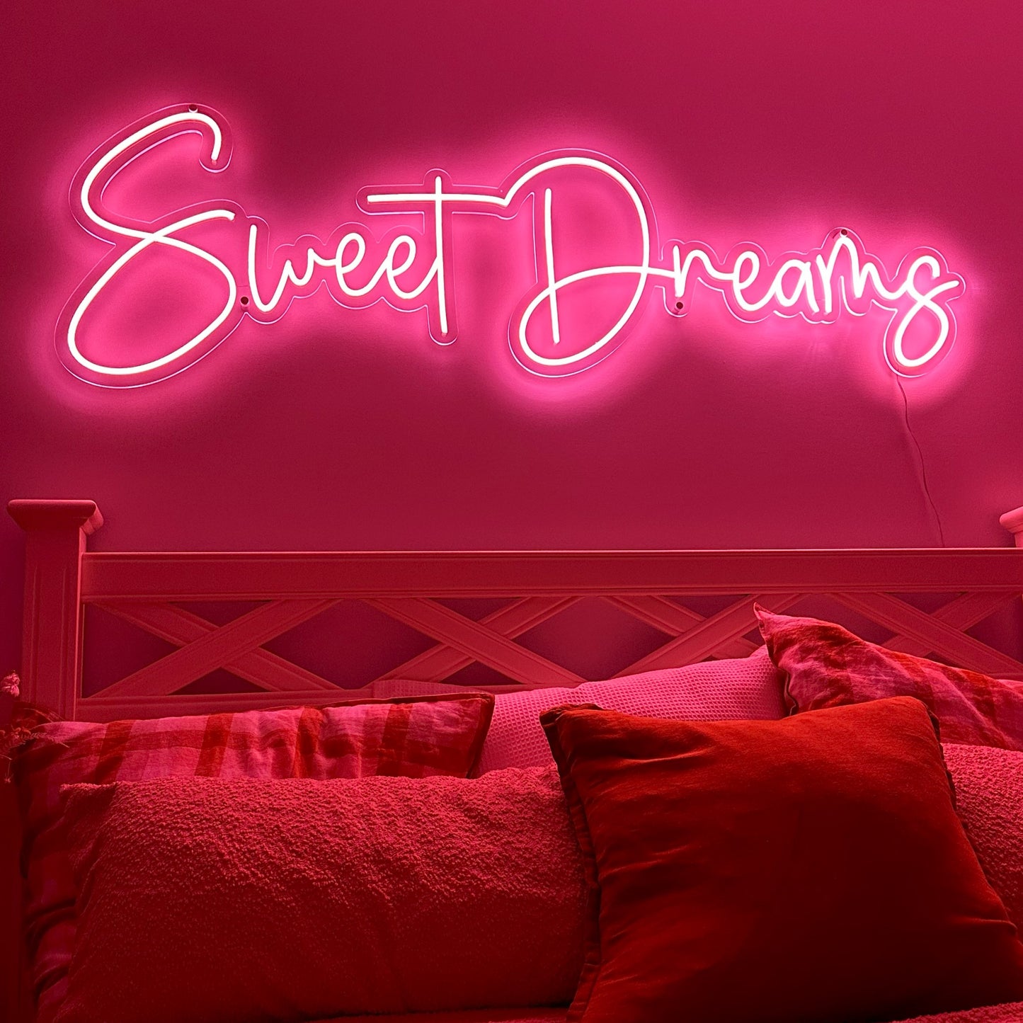 Sweet Dreams soft pink led neon light over queens size bed