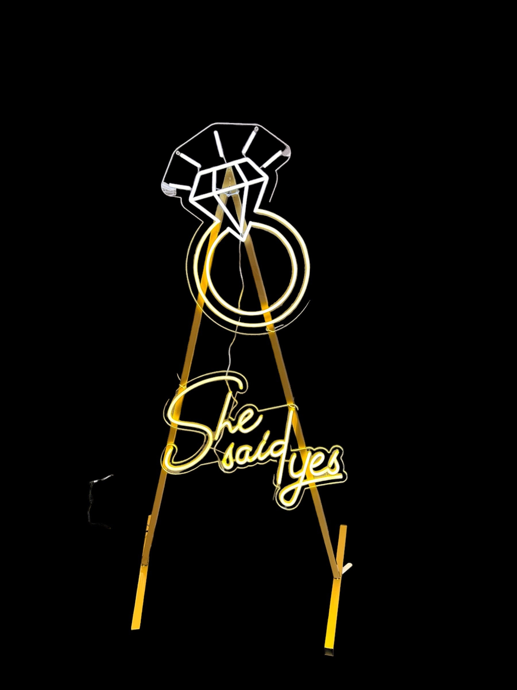 she said yeas and diamond ring neon signs attached to a gold stand