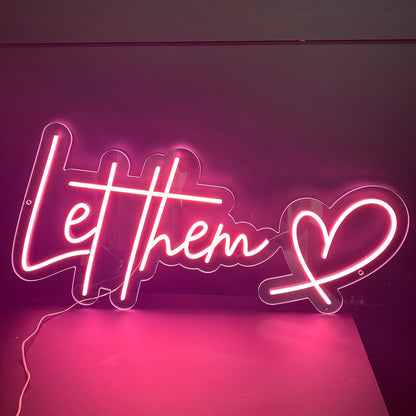 "Let them" quote with a heart symbol sof pink neon sign