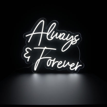 An LED neon sign with the words 'Always & Forever' in a cursive and elegant font, glowing in white against a black background.