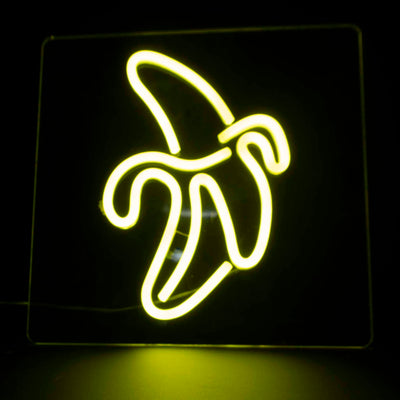 A yellow neon banana half peeled, on a clear acrylic tile background