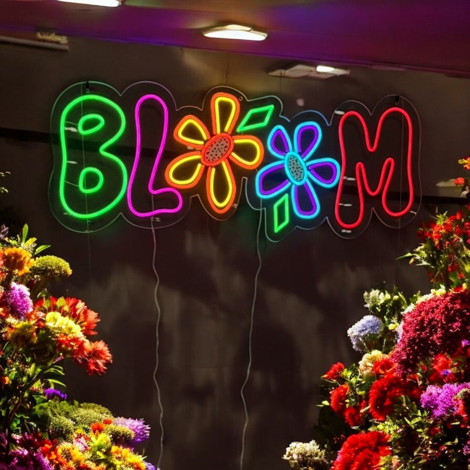 Multi-coloured Bloom LED neon sign above fresh flowers in a florist
