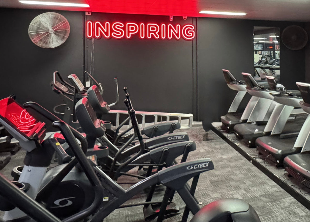 Inspiring red LED neon sign above the cardio machines at Fernwood Fitness