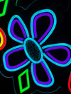 a close up of the bue and purple neon flower in the bloom signage