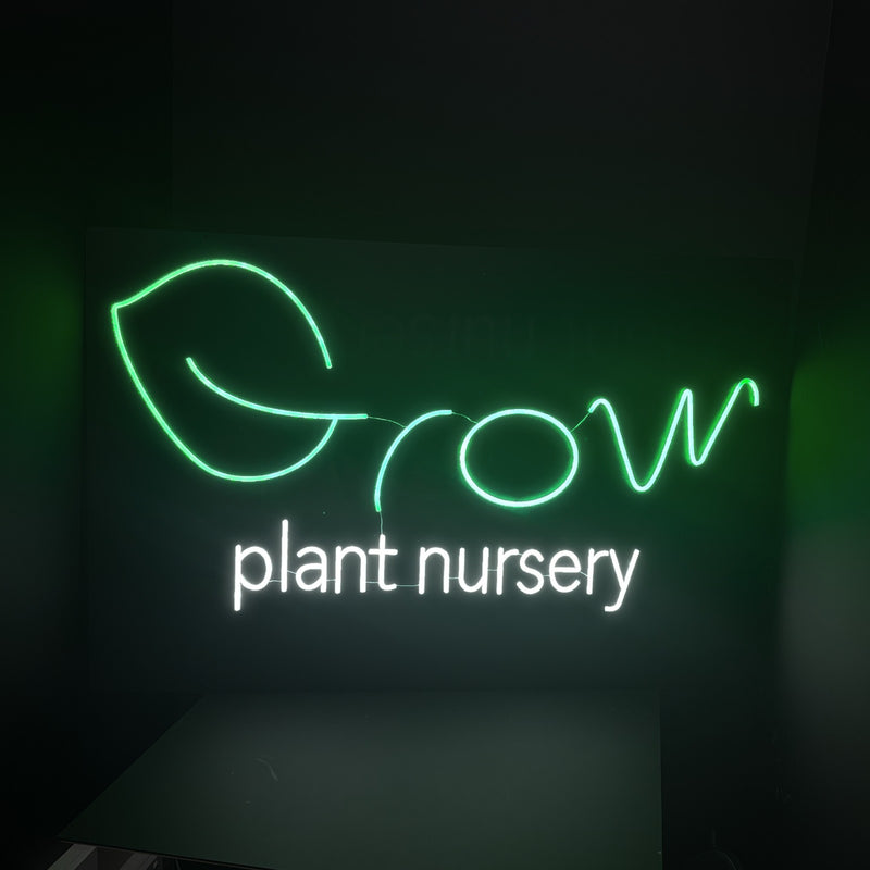 Grow Plant Nursery logo neon sign with a green leaf and white lettering