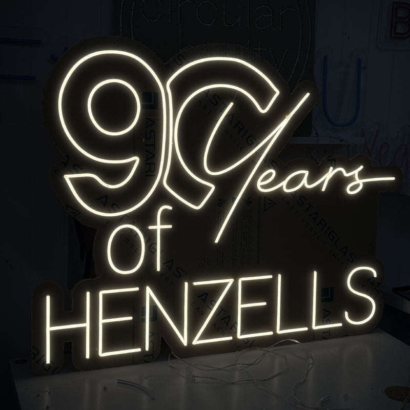 90 Years of Henzells anniversary neon sign in warm white