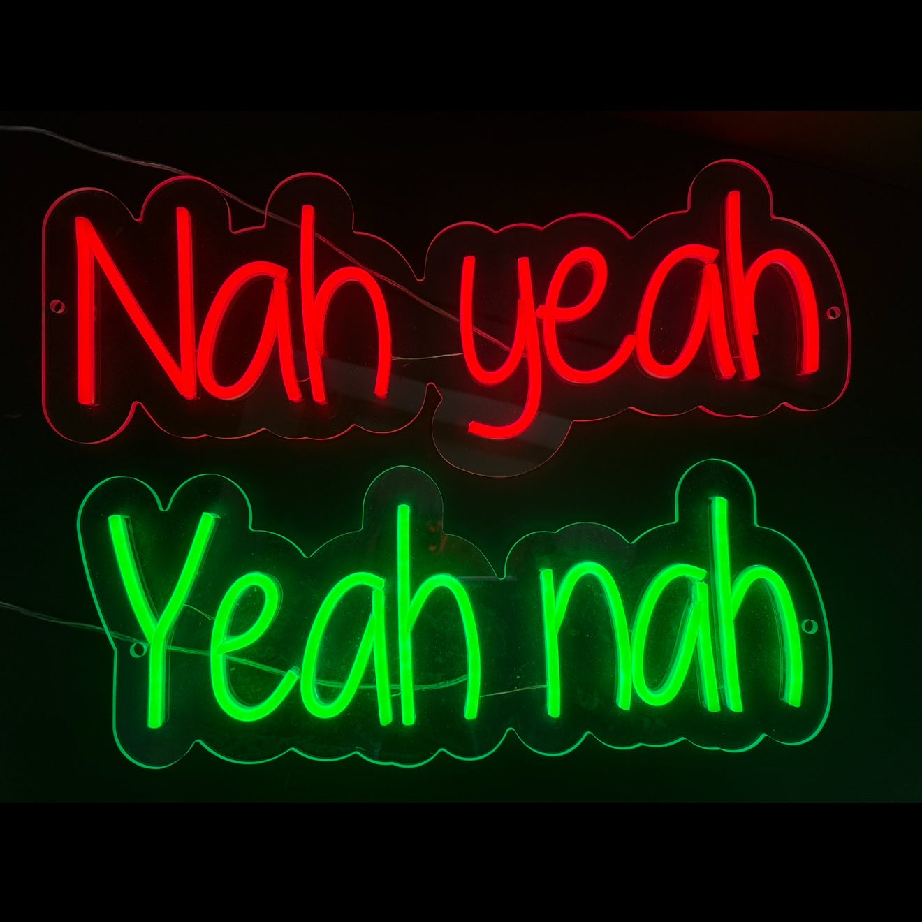 Neon sign with 'Nah yeah' in red and 'Yeah nah' in green on a black background