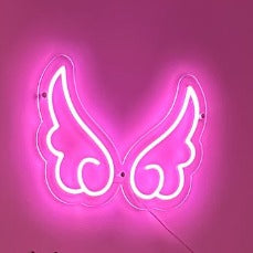 pink-neon-angel-wings-sign-wall-mounted-on-a-glowing-pink-background