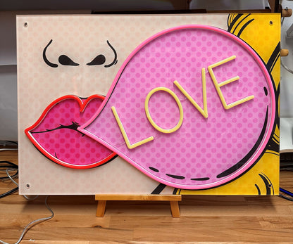 the word love in a speech bubble pop art artwork with neon applied to highlight the artwork.