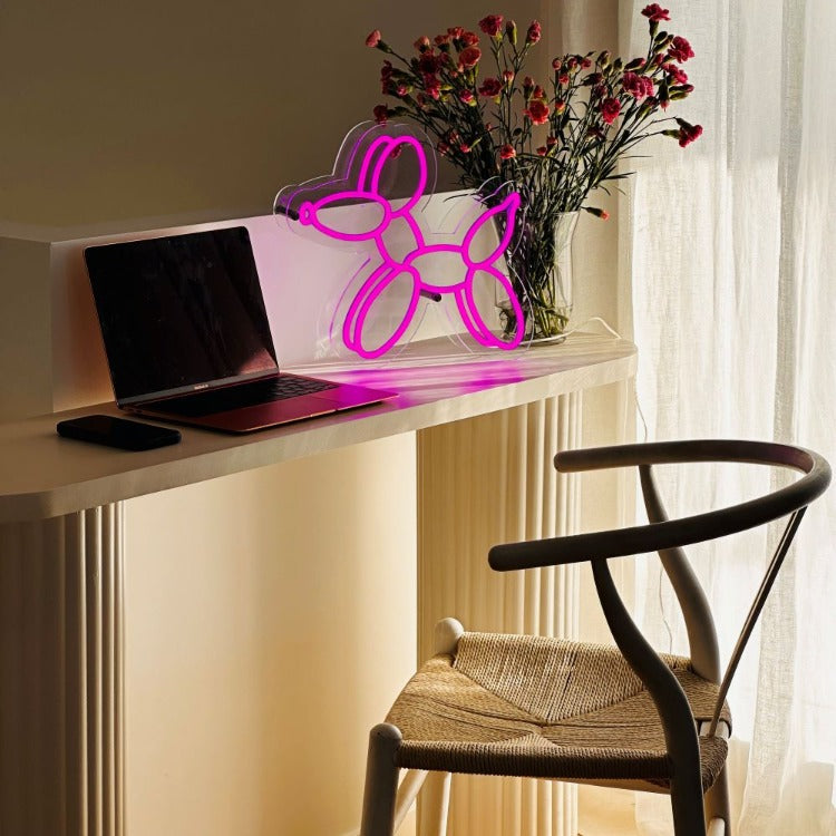 purple-balloon-dog-neon-light-on-a-computer-desk-with-a-computer-chair-and-table