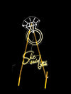 she said yeas and diamond ring neon signs attached to a gold stand