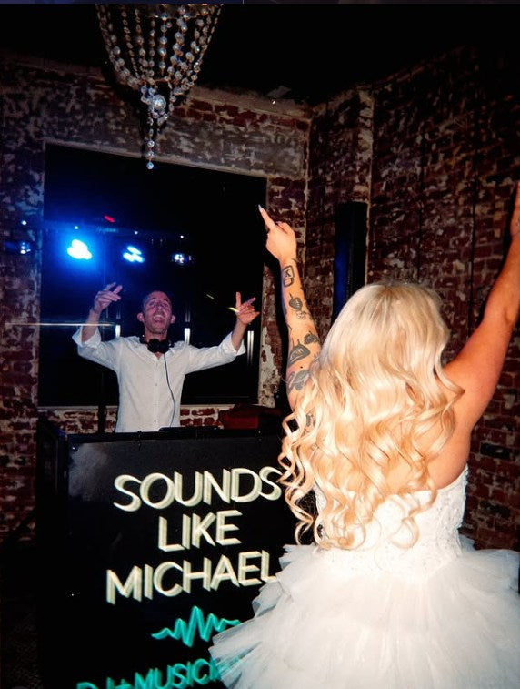Sounds Like Michael neon DJ booth sign at a wedding