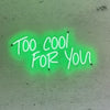 bright green neon sign &quot;too cool for you&quot; mounted on a concrete wall